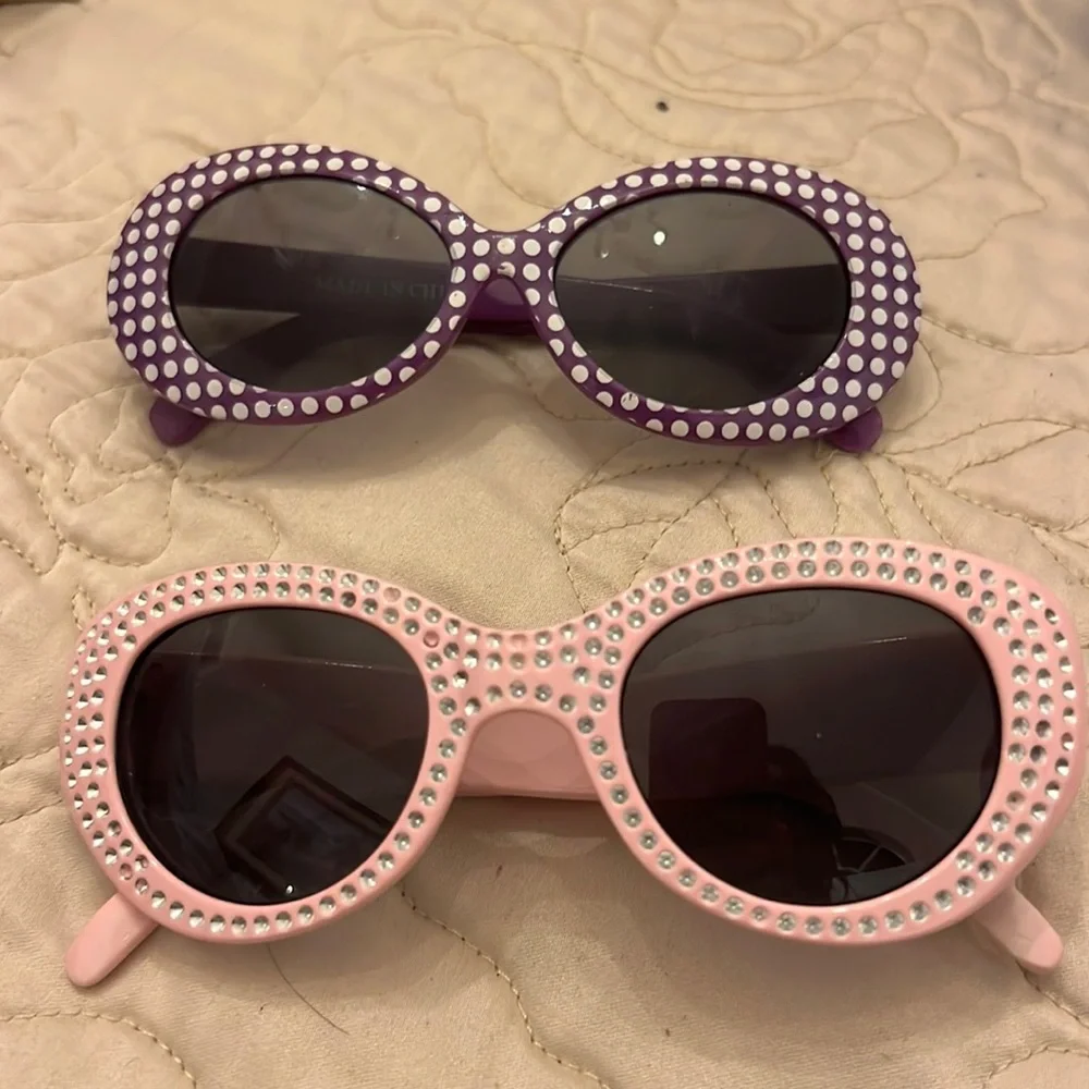 Two little girls sunglasses used in good shape pink and purple